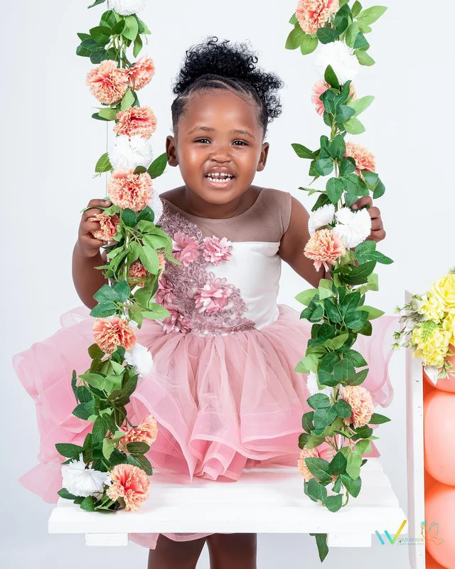 Birthday photoshoot, girl on a floral swing