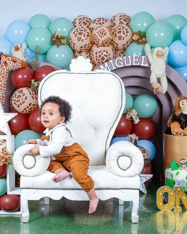 Baby portrait on a throne chair, teddy bear backdrop