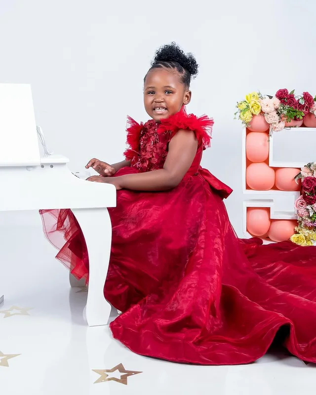 Birthday photoshoot at a white piano, red gown