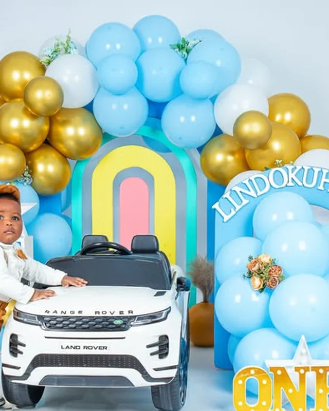 First birthday photoshoot, toy car and gold balloon arch