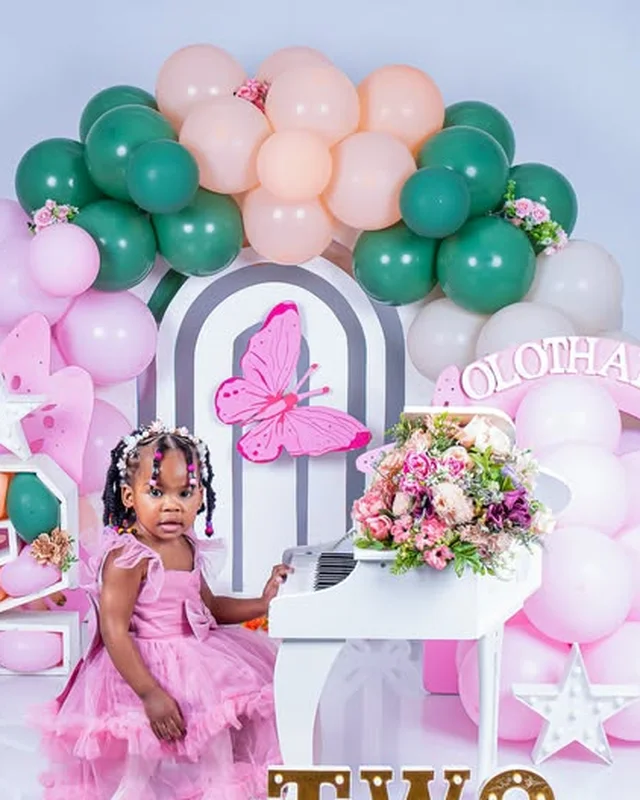 2nd birthday photoshoot at a toy piano, green and blush balloon arch