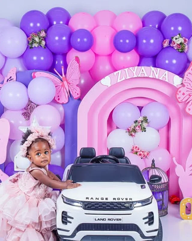 First birthday photoshoot, toy car and purple balloon arch