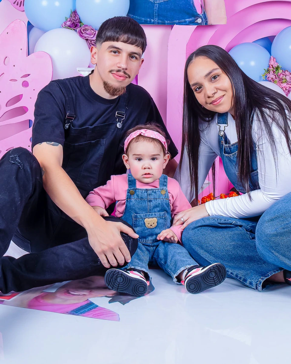 Family photoshoot, parents and toddler at a birthday backdrop